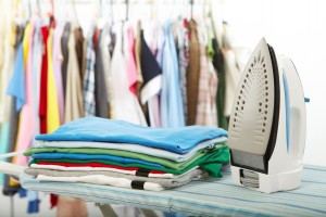 Electric iron and shirt, on cloth background